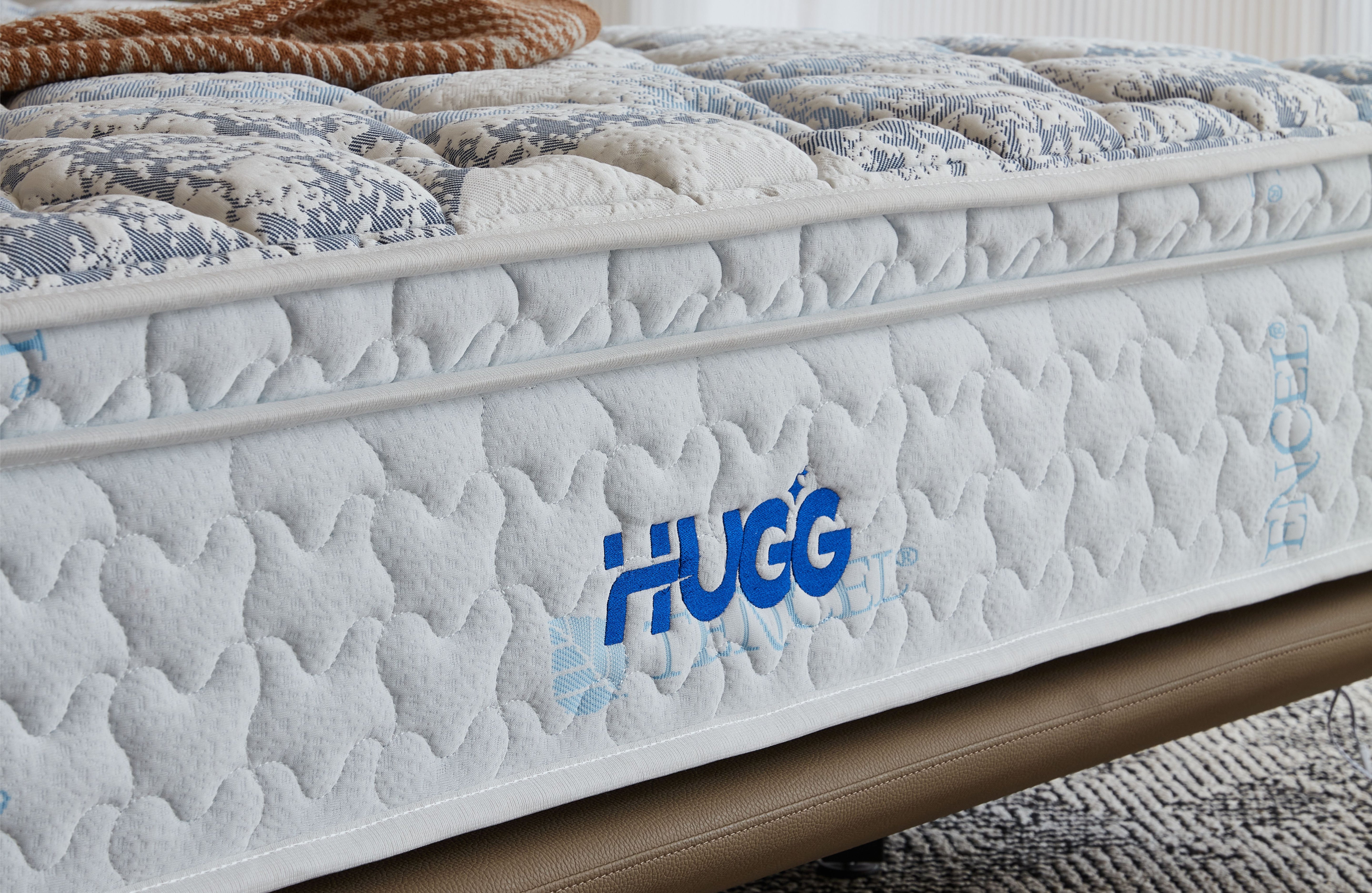 Mattress with 'Hugg' branding on a neutral background