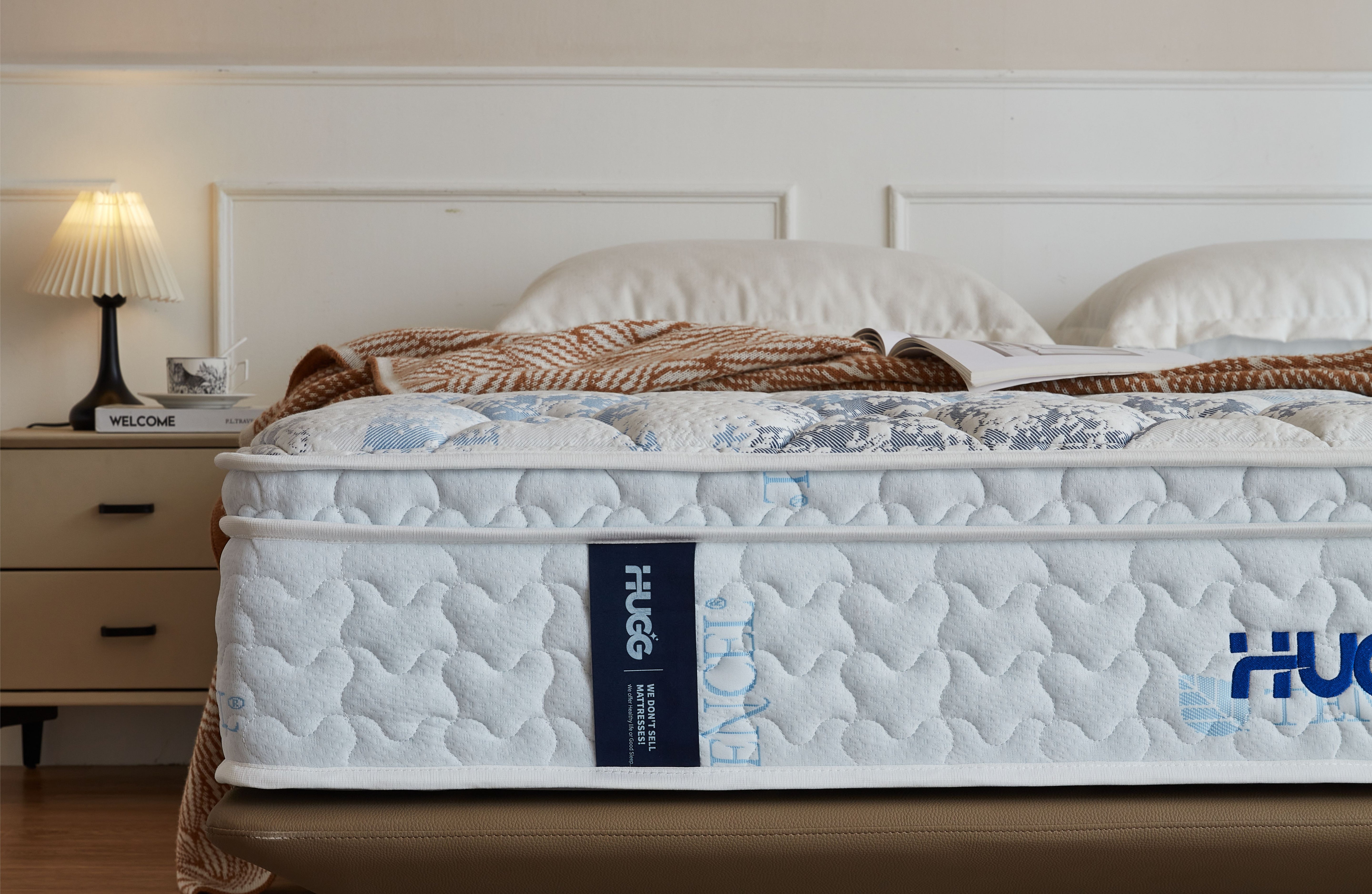 Mattress with 'HUG' branding on a bed in a bedroom setting