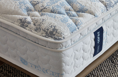 Close-up of a mattress with TENCEL branding and a visible tag.