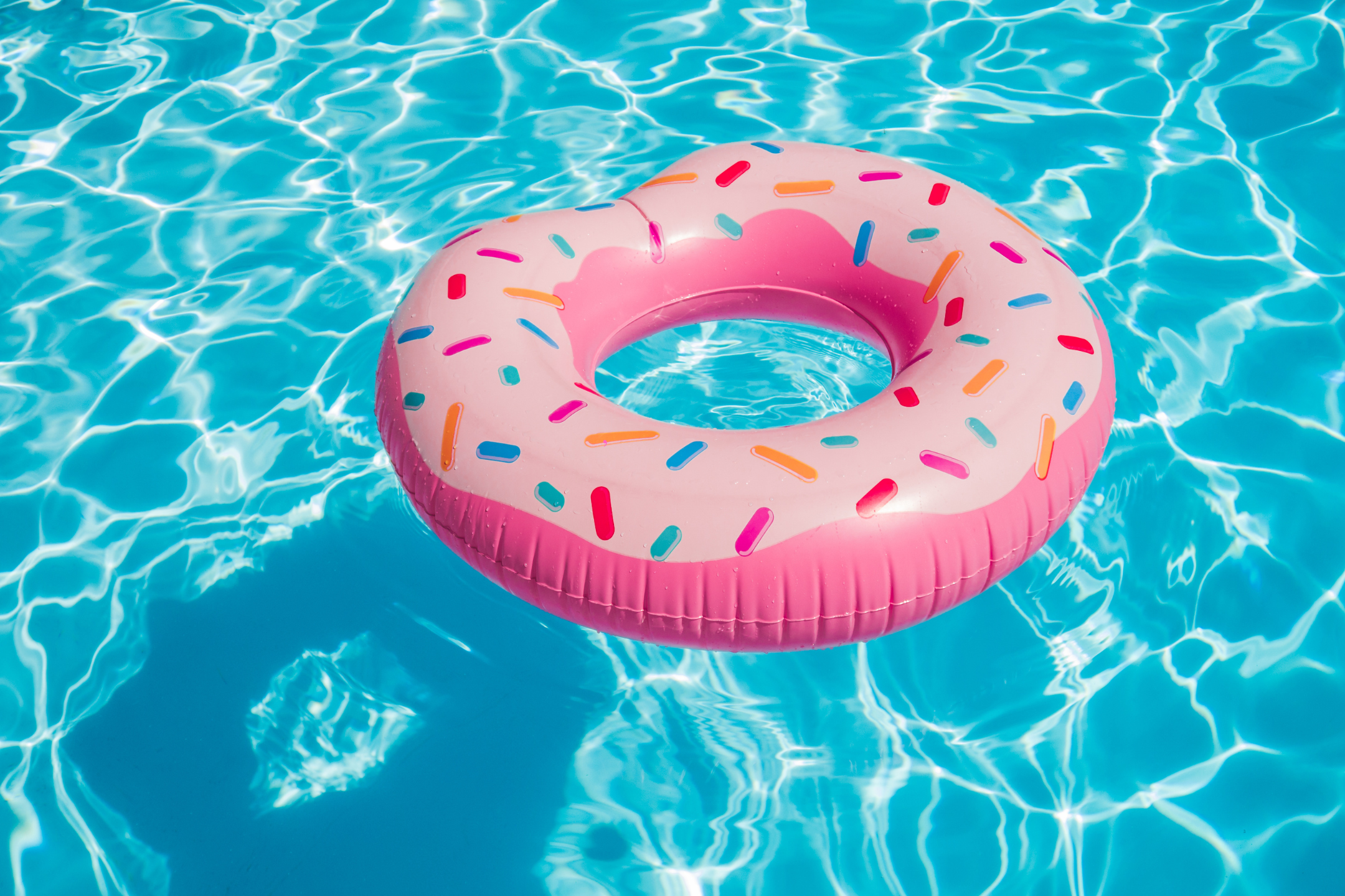 Pink inflatable donut pool float with 